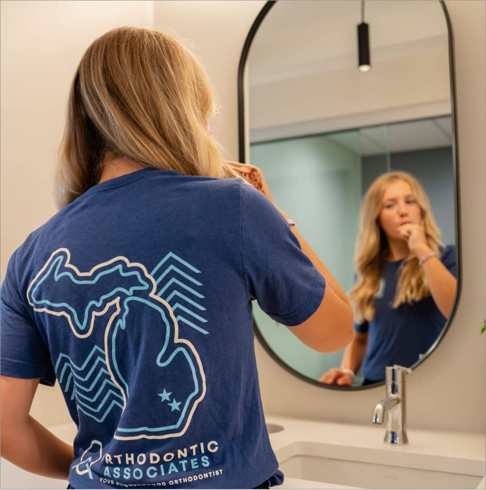 teen girl brushing teeth during appointment
